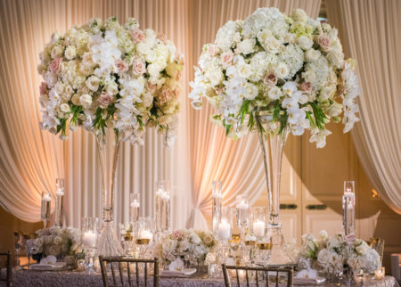 Beautiful and elegant flower centerpieces at indoor wedding reception. 