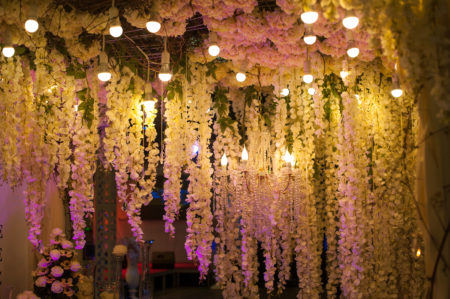 Stunning hanging flower ceiling installation at indoor wedding. 