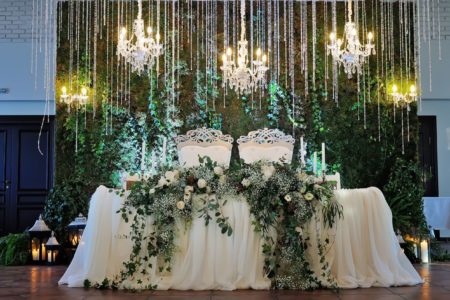 Sweetheart table for two with white linen an white and green flowers