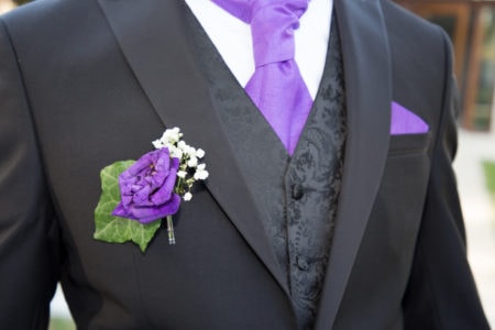close up of beautiful black purple and white wedding groom suit