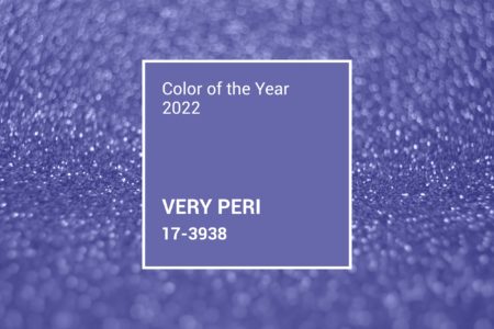 Very peri color of the year 2022. Trendy concept. Lights on violet background. Bokeh defocus disco effect. Holiday abstract christmas lights garland. Winter festive shine sparkle glitter macro