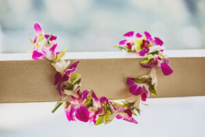 Orchid lei on wooden beam