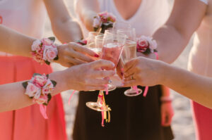 Hands with corsages making a toast