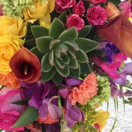 Closeup of bridal bouquet featuring succulents, roses, calla lilies, carnations and more.