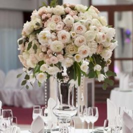 Extravagant floral centerpiece of ranunculus and garden roses